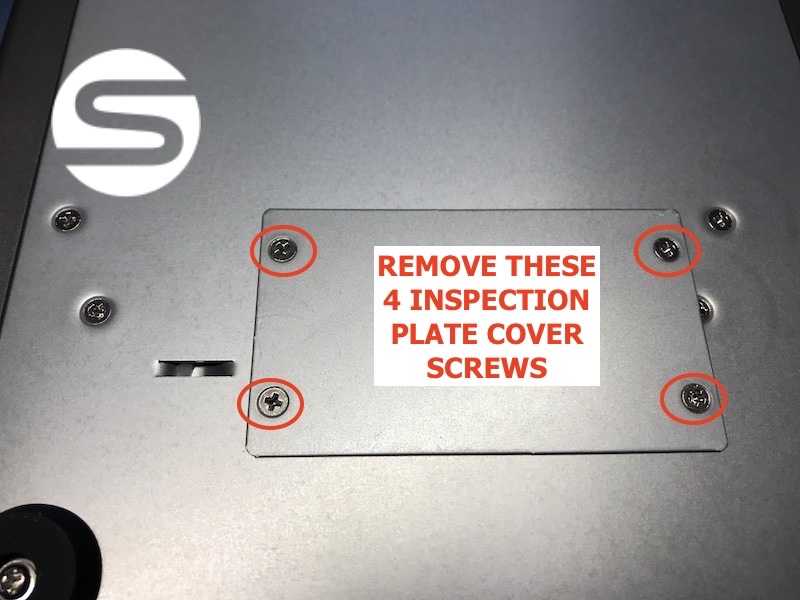 Underside of the SymplyPRO LTO Desktop unit showing the inspection panel with the four cover plate screws circled in red