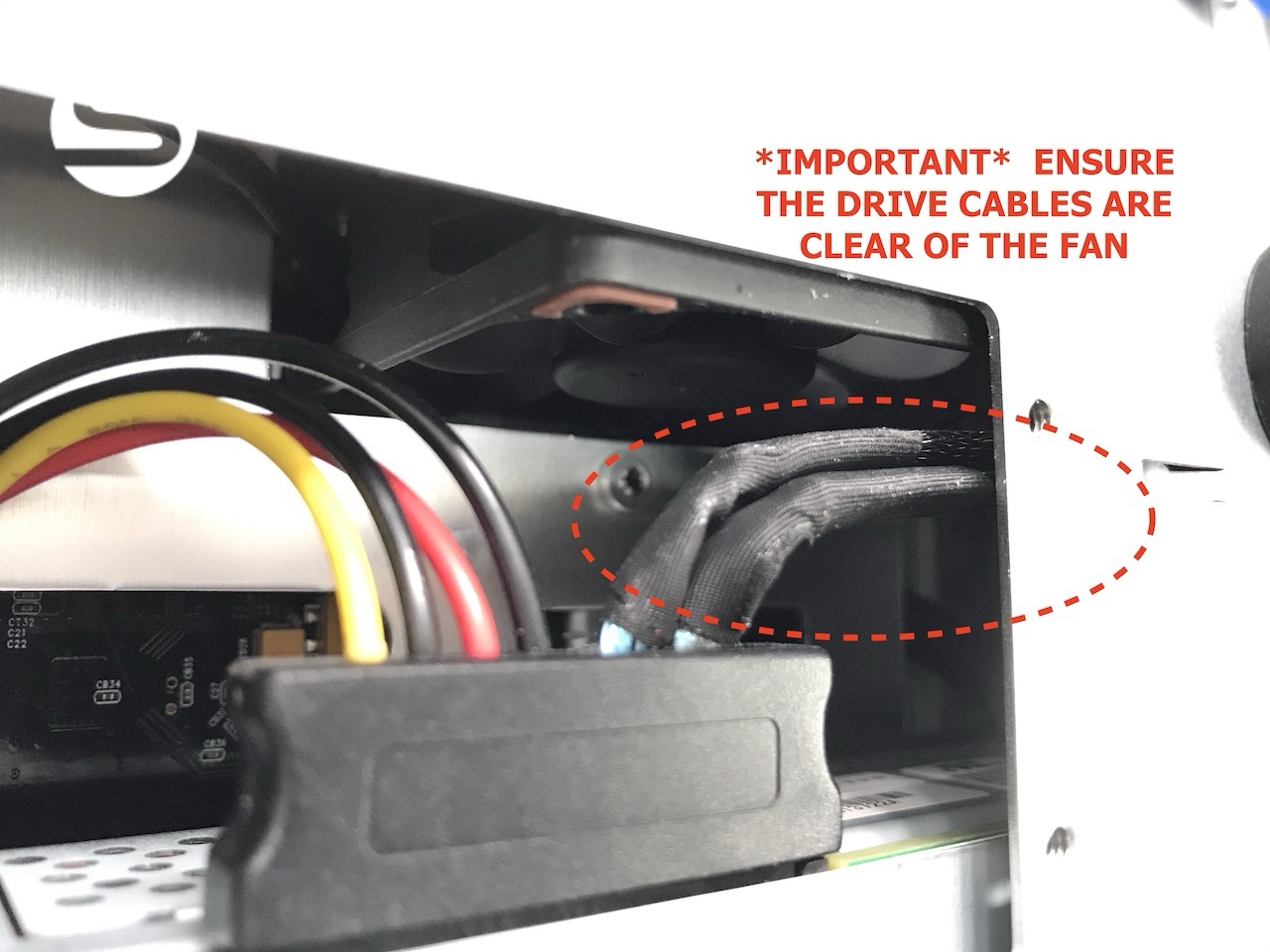 Interior view showing the drive cabling routed clear of the rear fan, with the fan area highlighted
