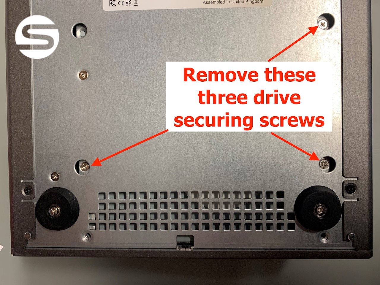 Underside of the chassis with the three LTO drive securing screws indicated by red arrows