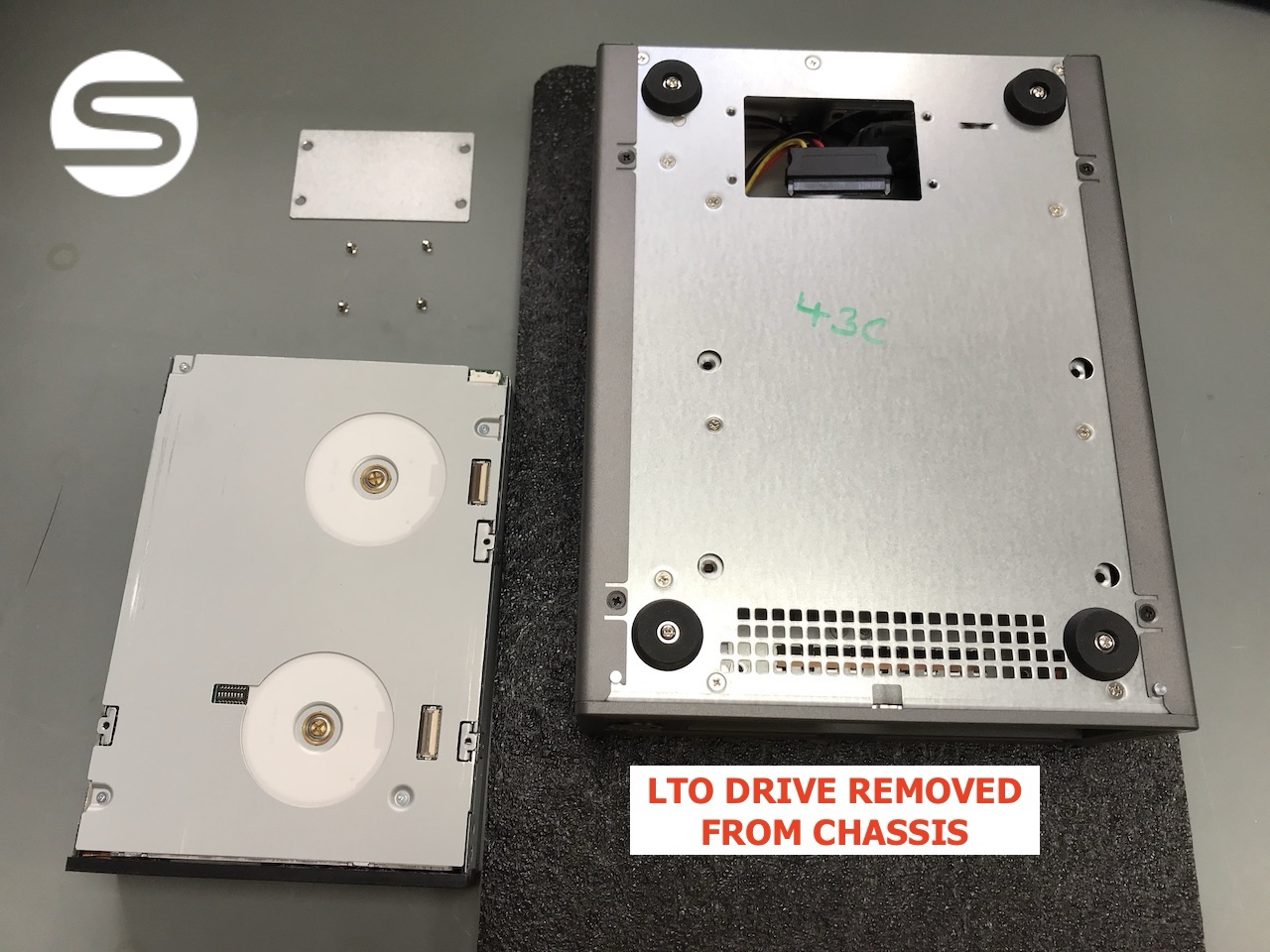 The LTO drive fully removed and sitting beside the empty chassis