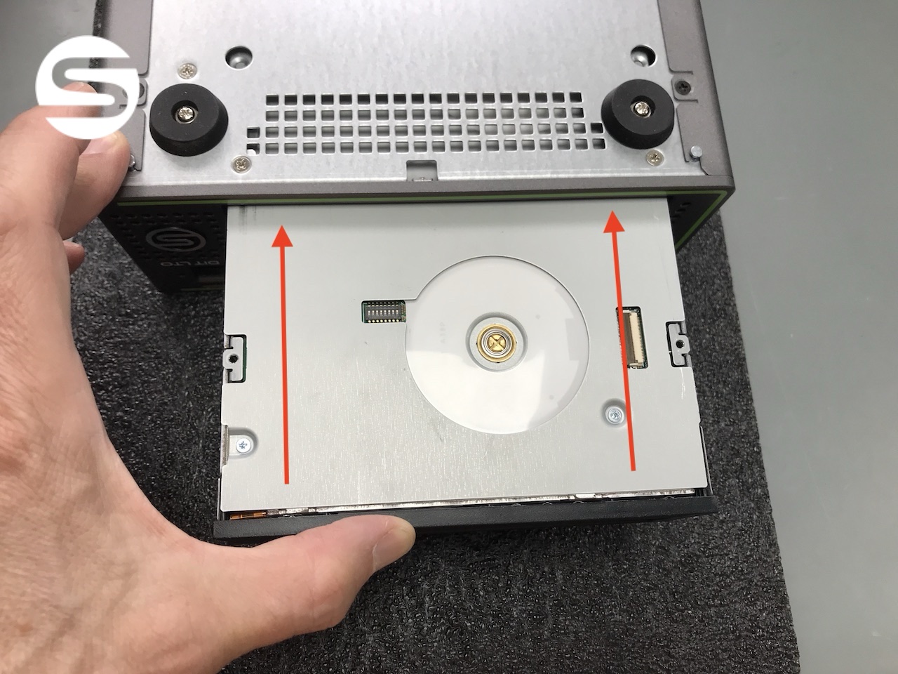 Sliding the replacement LTO drive back into the chassis from the front