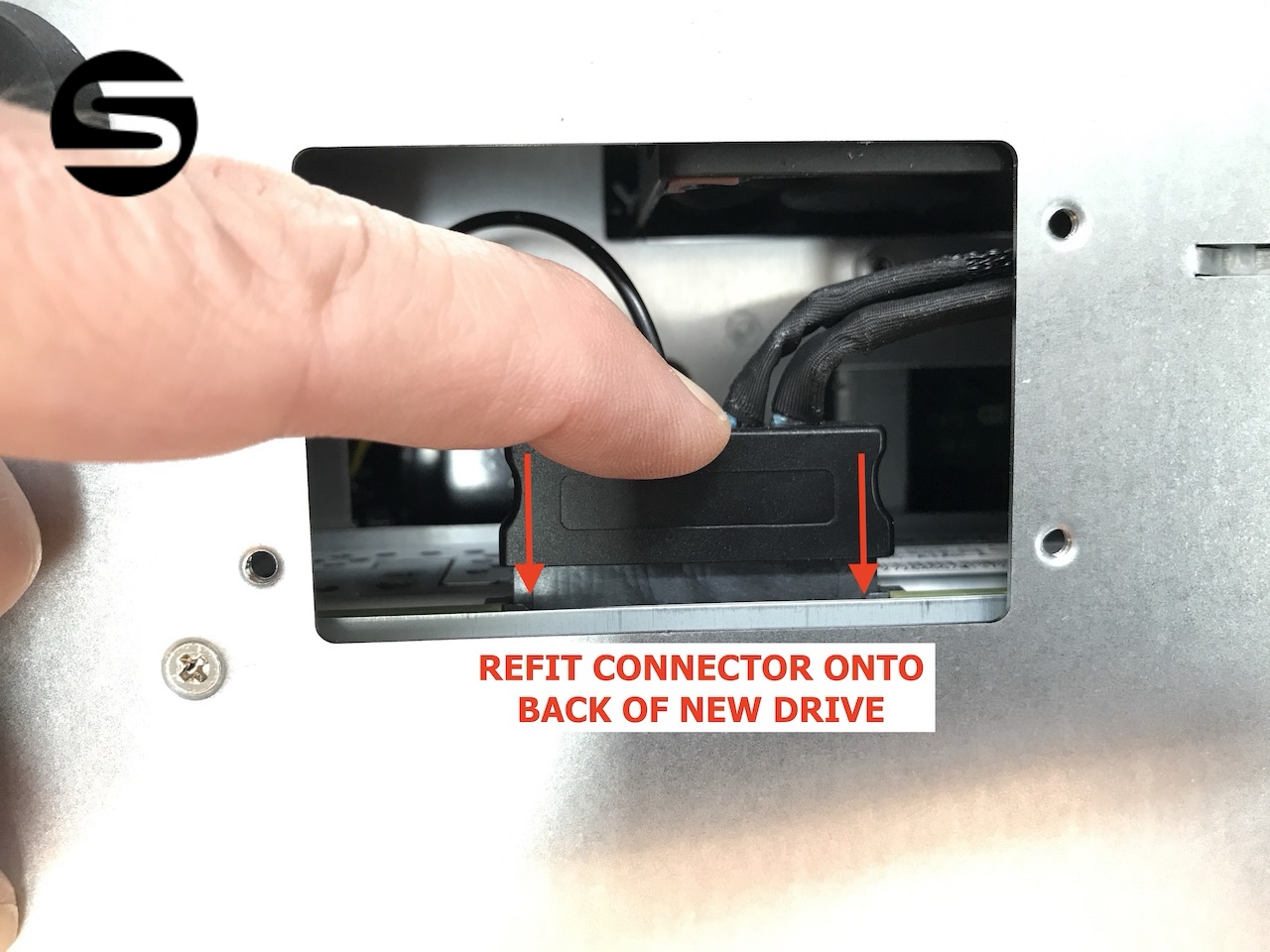 Refitting the connector onto the rear of the newly installed drive through the inspection panel
